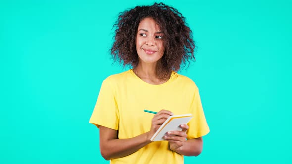 Young Woman Making Notes in Planner African Lady Holding Pen