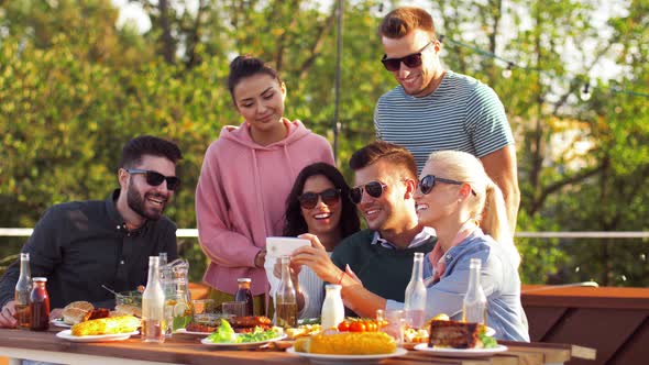 Happy Friends Using Smartphone at Rooftop Party 17