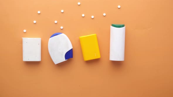 Artificial Sweetener Containers on Orange Background