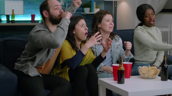 Group of Mixed People Watching Sport on Television at Home