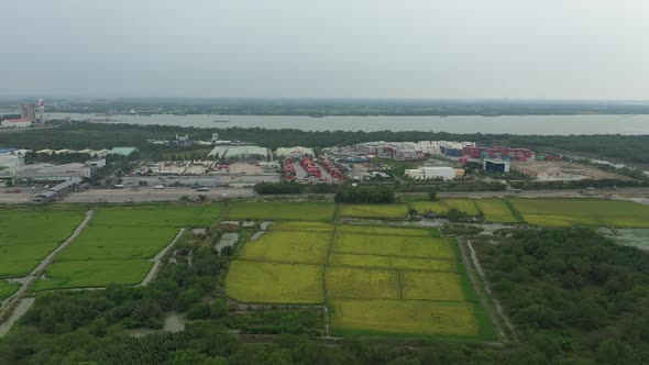 panoramic drone shot of rice fields and development on the outskirts of Ho Chi Minh City, Vietnam. S