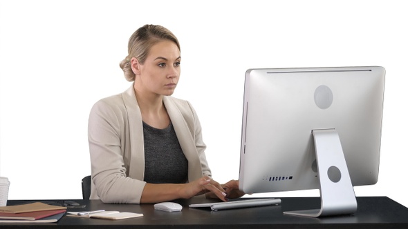 Classy happy businesswoman working at computer, white background