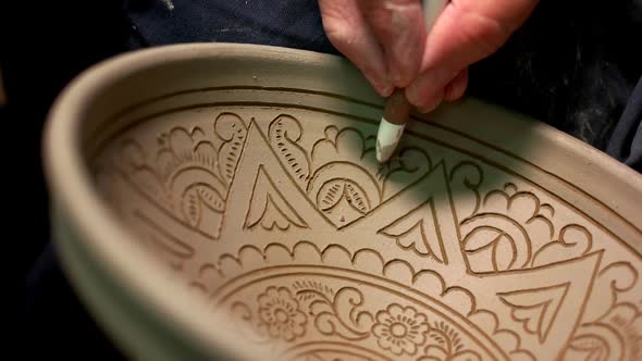 Potters Hand Drawing Design on Clay Bowl