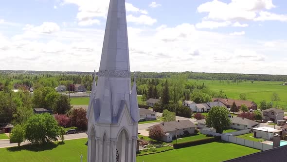 Aerial shot rising beside Catholic church in rural Quebec Canada.