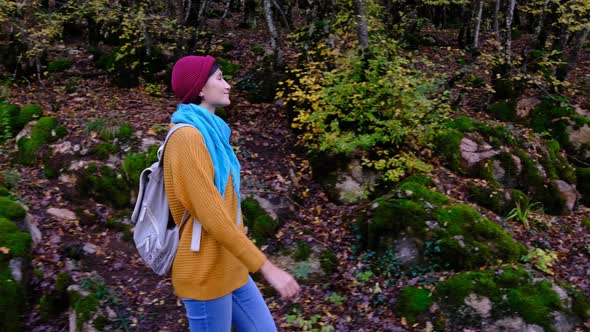 Pretty Smiling Asian Woman Walks in Autumn Woods