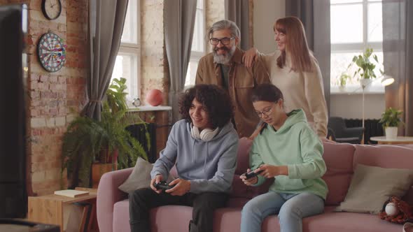 Family Having Fun while Playing Console Game at Home