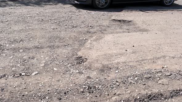 Damaged Road with Dangerous Pot Hole