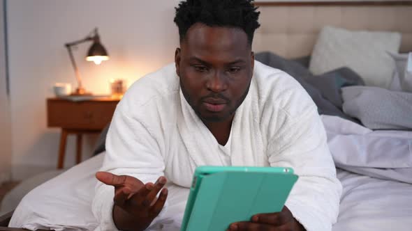 Dissatisfied African American Man Talking Closing Tablet Holding Head in Hands