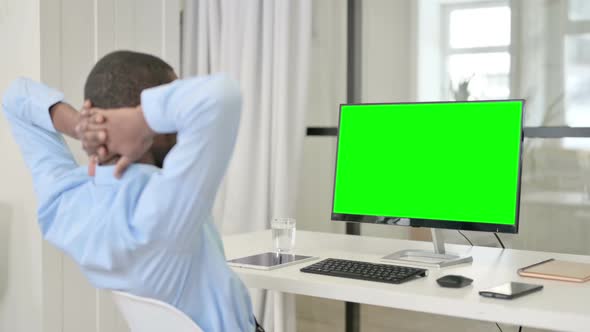 Businessman Resting While Using Desktop with Green Chroma Key Screen