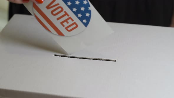 USA Elections, Woman Voter Putting a Vote in a Ballot Box