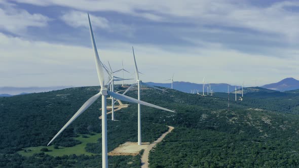 Wind turbines, renewable energy on a green hill