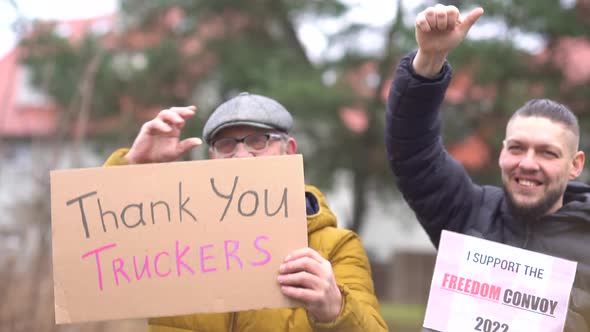 Portrait of People with Posters Thank you Truckers and Freedom Convoy on Every Sunday March Against