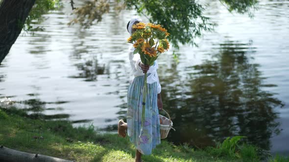 Wide Shot Cheerful African American Woman Stretching Bouquet of Sunflowers Smiling Looking at Camera