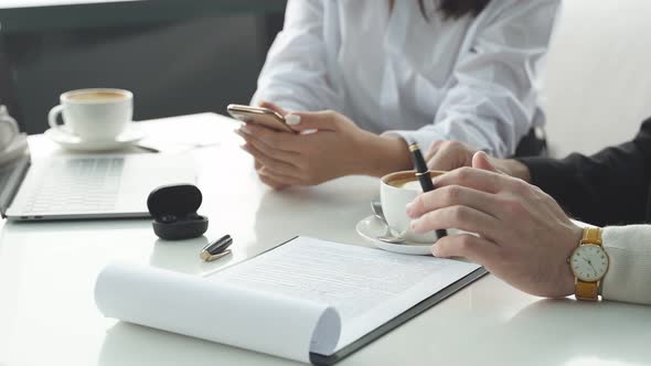 Business Meeting of Business People Men and Women They are Sitting at a Table and Drinking Coffee