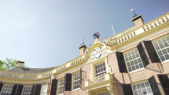 Tilt reveal shot of front exterior of Groeneveld Castle, Utrecht