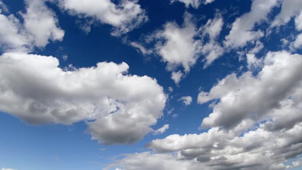 Large, dark cumulus clouds move across the sky