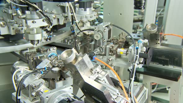 Advanced industrial production line for small parts, robotic arms working