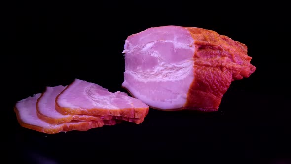 A piece of boiled pork on a dark background and cut into pieces