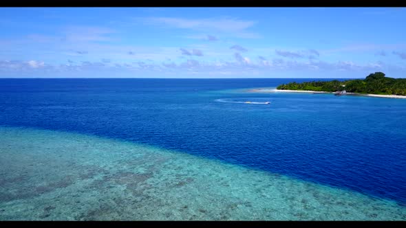 Aerial drone shot seascape of luxury coastline beach journey by turquoise lagoon and white sand back