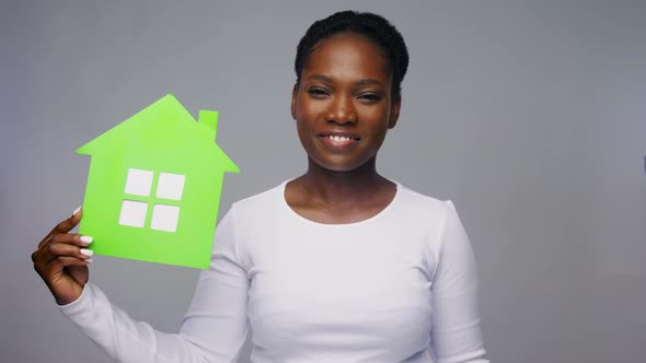 Smiling African American Woman Holding Green House