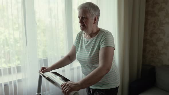 Elderly Woman in Rehabilitation Walking on a Treadmill