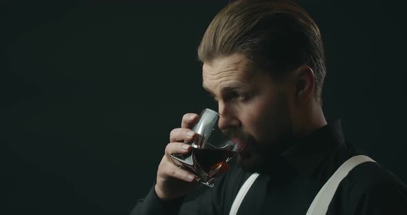 Man Drinking Whiskey On Black Background