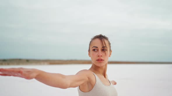 Yoga Woman Practices at Beach Working Out and Relaxing Outside on Beach at Sunrise