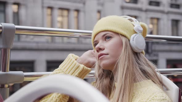 Blond Teenage Tourist With Headphones On Bus