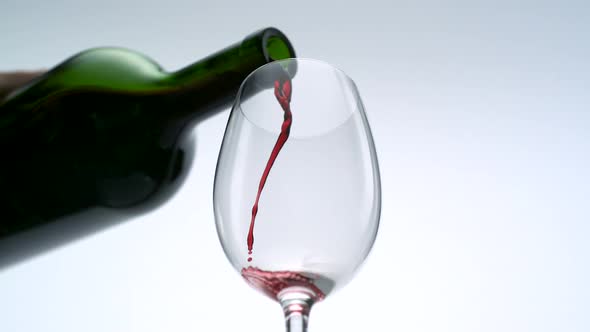 Pouring red wine into glass, Slow Motion