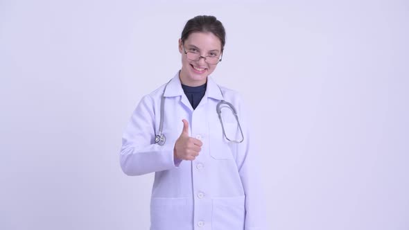 Happy Young Beautiful Woman Doctor Giving Thumbs Up