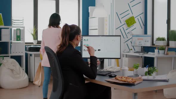 Multitasking Businesswoman Talking at Landline Explaining Company Graphs to Remote Collegue