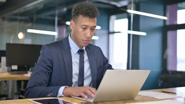 Attractive Young Businessman Looking at the Camera and Smiling