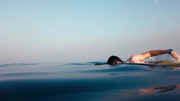 Man is swimming freestyle in the sea