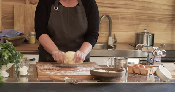 Woman kneading pasta dough for home made Maultaschen