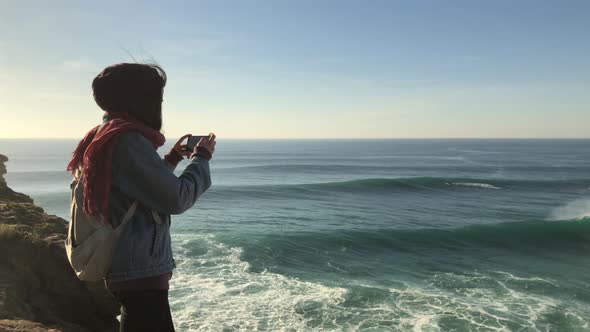 Young girl at the most popular natural sightseeing of Portugal