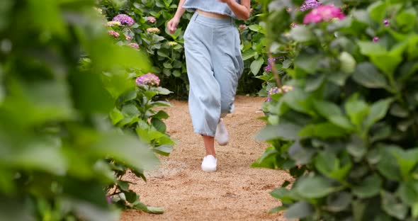 Woman running in the flower farm
