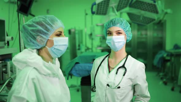 Two Professional Female Doctors in Green Hospital Room