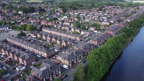 Aerial view flying above wealthy Cheshire real estate housing property descending right pan shot