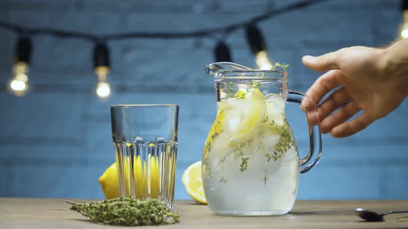Male hand stirring lemonade