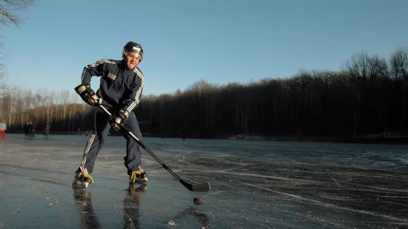 MOSCOW RUSSIA 10 DECEMBER 2019 Ice Hockey Player Training with Dribbling on Frozen Lake Professional