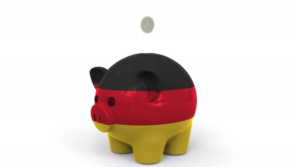 Coins Fall Into Piggy Bank Painted with Flag of Gemany alt