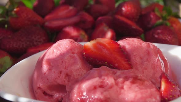 Closeup of Fresh Delicious Strawberries Falling on the Strawberry Ice Cream
