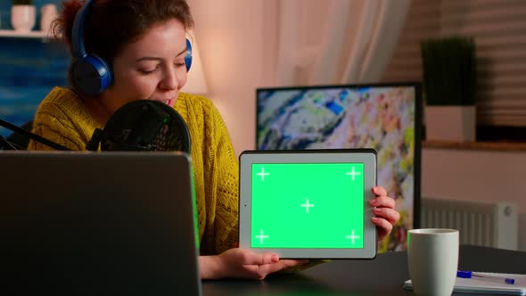 Blogger Talking Into Microphone Holding Notepad with Green Screen
