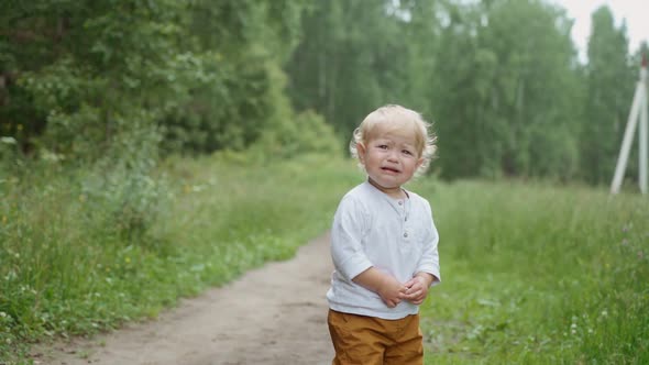 portrait of a child in the park. crying baby . parenting concept.