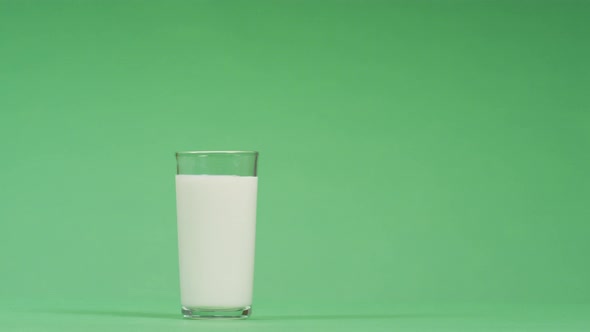 Hand taking a glass of milk