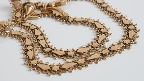 Detailed golden necklace chain close-up 4K  panning video