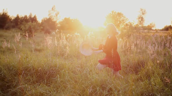 Portrait of Positive Smiling Woman Looking Into Camera at Sunset