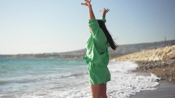 Side View of Happy Young Woman Inhaling Fresh Air Raising Hands Admiring Beauty of Picturesque