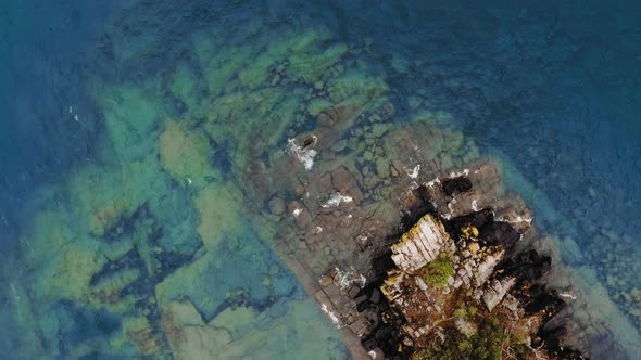 Drone shooting a small rocky island with autumn tree in Lake Superior, Great Lakes, Ontario, Canada