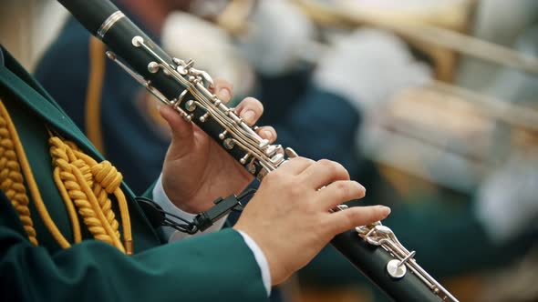 A Wind Instrument Parade - a Man in Green Costume Playing Clarinet at the Military Music Festival